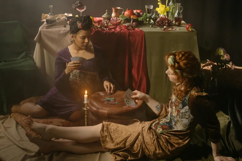 a couple of women sitting on top of a bed, inspired by Georges de La Tour, pexels contest winner, renaissance, princess at a royal banquet, fortune teller, production still, promotional image