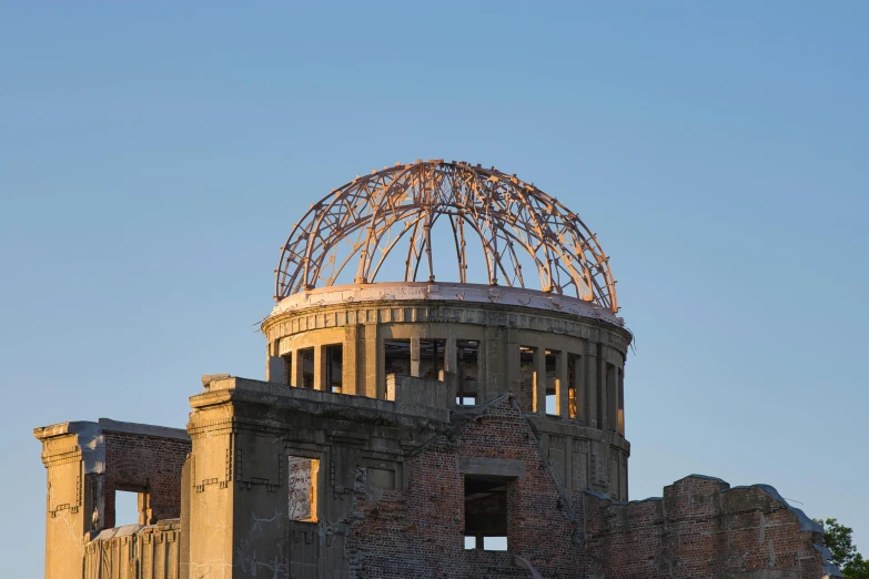 a large building with a dome on top of it, inspired by Tsuchida Bakusen, unsplash, nuclear art, explorers of the ruins at dusk, blue sky, government archive photograph, exposed inner structure