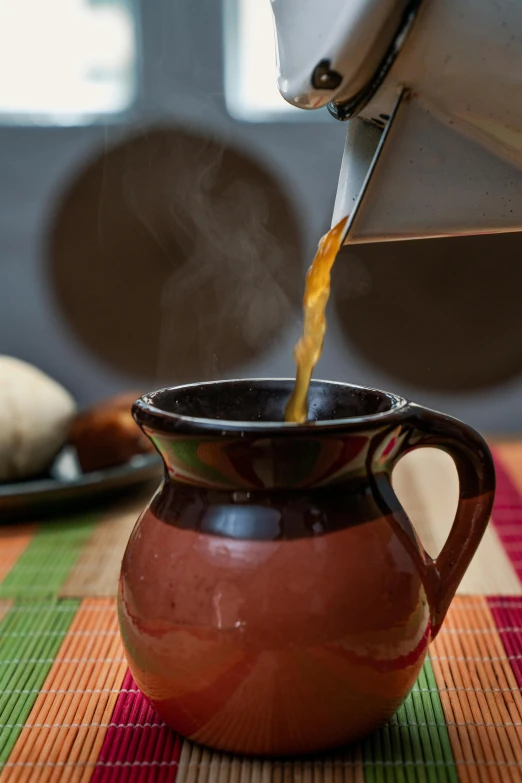 a person pouring tea into a cup on a table, by Juan O'Gorman, mayan, hot food, square, medium closeup