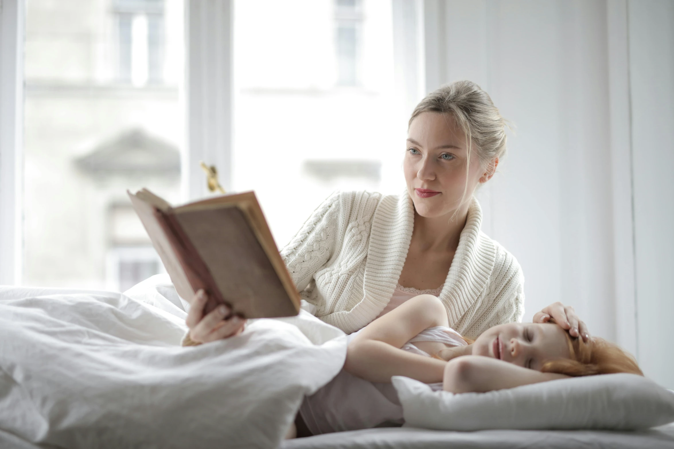 a woman reading a book to a baby on a bed, a picture, pexels contest winner, figuration libre, looking to the right, avatar image, full daylight, high resolution image