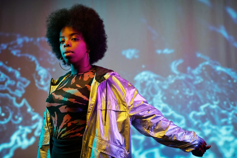 a woman that is standing on a stage, an album cover, pexels, afrofuturism, backlit shot girl in parka, museum quality photo, vibrant: 0.75, black teenage girl