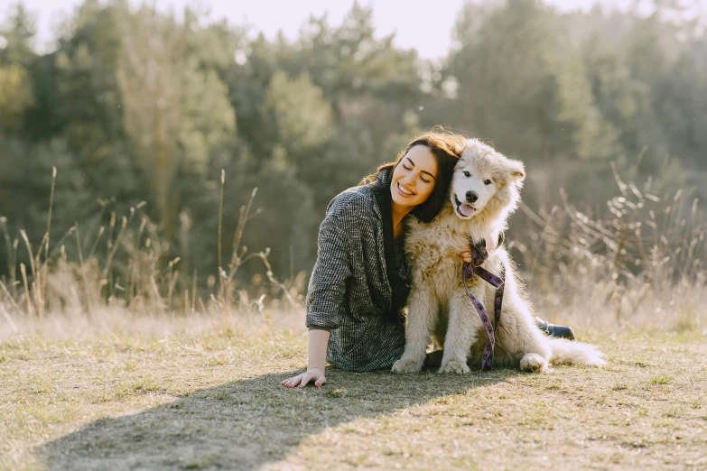 a woman sitting on the ground with a dog, profile image, looking happy, aussie, hugging