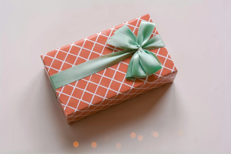 a small orange gift box with a green bow, pexels contest winner, arabesque, pastel colors only, rectangle, small, thumbnail