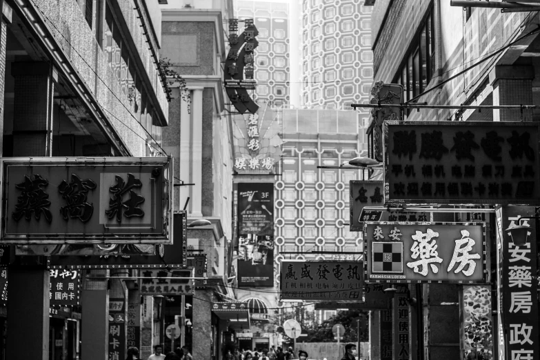 a black and white photo of a city street, a black and white photo, artwork of a hong kong street, dressed in ornate, vertical composition, signboards