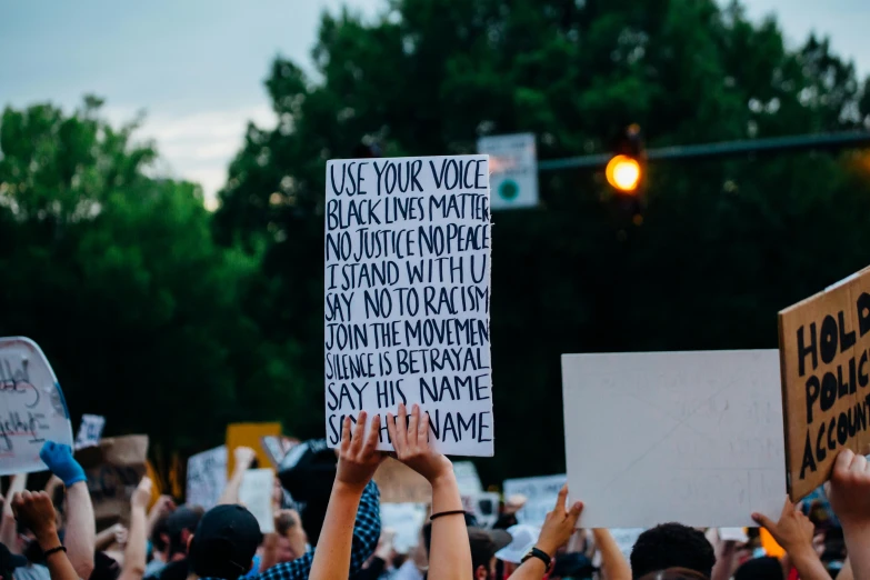 a group of people holding up signs in the air, a photo, by Carey Morris, trending on pexels, black marker, a person standing in front of a, violent protest, cel - shaded