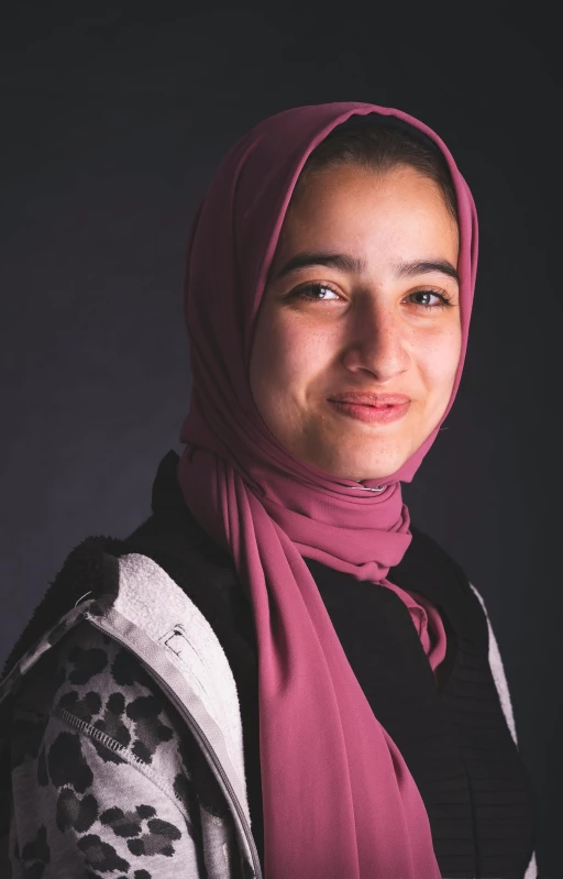a close up of a person wearing a scarf, by Maryam Hashemi, yearbook photo, standing with a black background, young teen, portrait n - 9