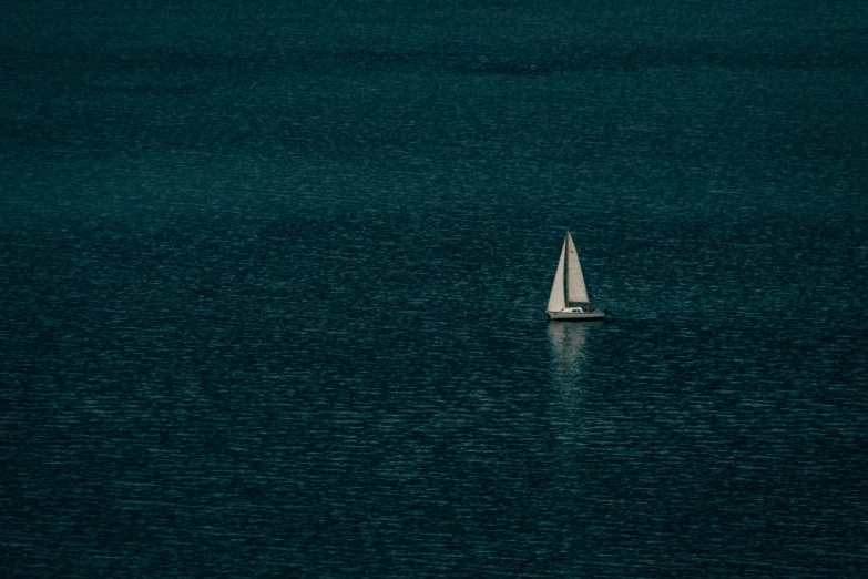 a sailboat in the middle of a large body of water, inspired by Elsa Bleda, fan favorite, shot on canon eos r 5, kai vermehr, dingy