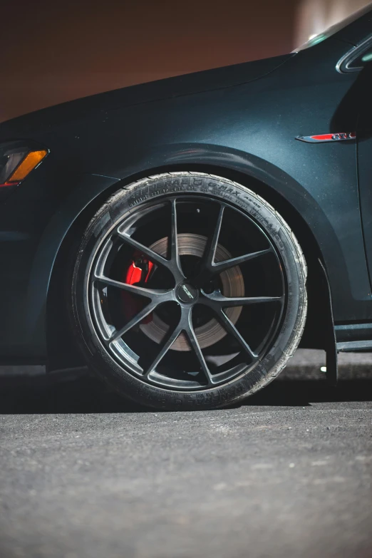 a black car parked on the side of the road, detailed alloy wheels, photograph taken in 2 0 2 0, performance, anthracite