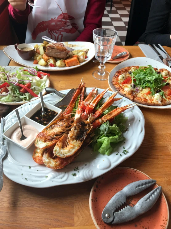 a group of people sitting at a table with plates of food, prawn, in paris, realistic photo”, thumbnail