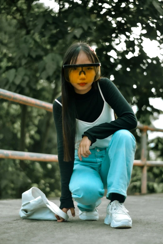 a woman sitting on the ground with a skateboard, inspired by Yi Insang, trending on pexels, yellow carrera glasses, avatar image, with teal clothes, sleek visor