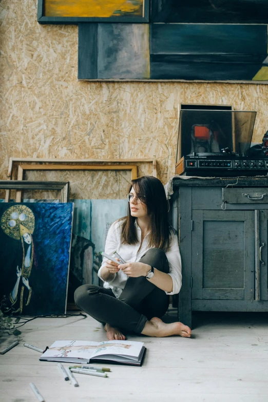 a woman sitting on the floor in front of a painting, album art, in a studio, art », multiple stories