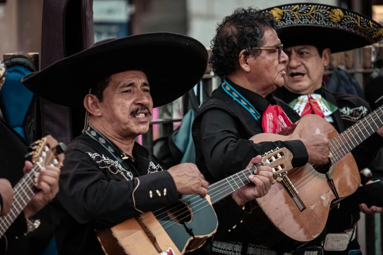 a group of men standing next to each other holding guitars, pexels contest winner, figuration libre, old mexican magician closes eyes, square, sombrero, performing