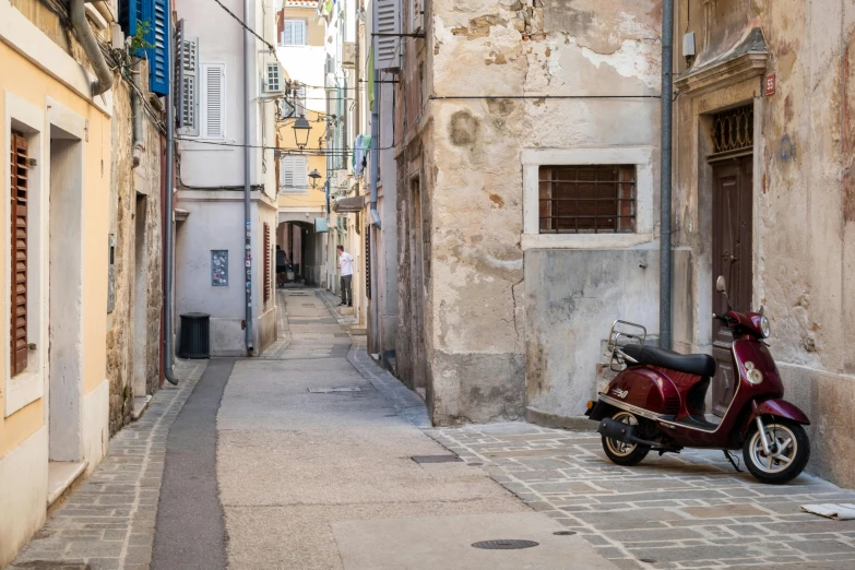 a scooter parked on the side of a narrow street, a picture, unsplash contest winner, baroque, chris pratt ancient corsican, trending on dezeen, biennale, youtube thumbnail