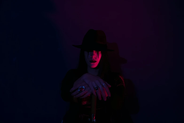a woman wearing a hat in a dark room, an album cover, inspired by Elsa Bleda, pexels contest winner, witch paying for her sins, black light, androgynous vampire, coherent hands