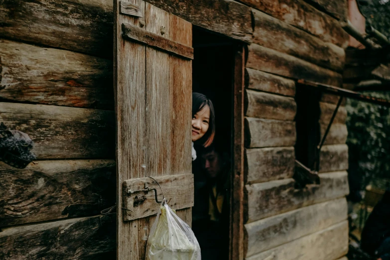 a woman standing at the door of a wooden cabin, pexels contest winner, mingei, happy kid, ruan jia and brom, avatar image, colonial exploration