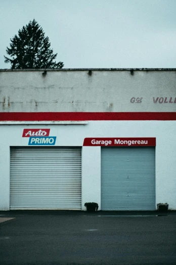 a garage with a fire hydrant in front of it, by Artur Grottger, postminimalism, villeneuve, bright signage, omg, low quality photograph
