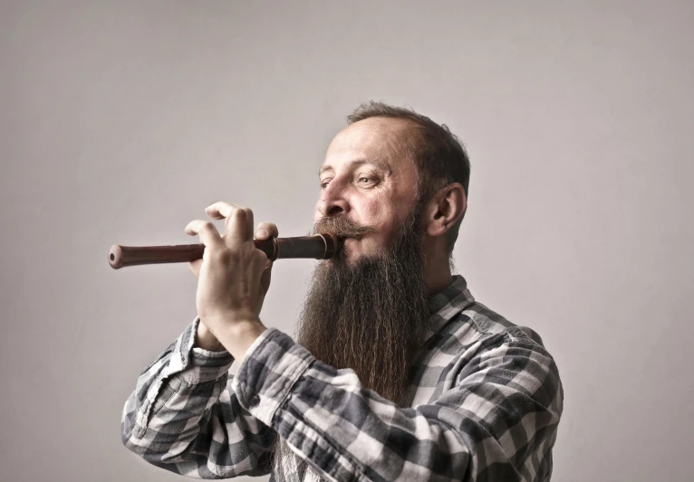 a man with a long beard playing a flute, inspired by János Donát, pexels contest winner, renaissance, plain background, water pipe, colin hay, redneck