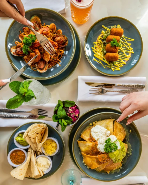 a table topped with plates of food and drinks, four hands, crispy, profile image, breakfast