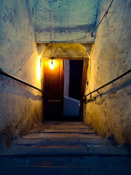 a set of stairs leading up to a door, an album cover, inspired by Carl Spitzweg, unsplash, candlelit catacombs, tallinn, narrow streets, 2 0 0 0's photo