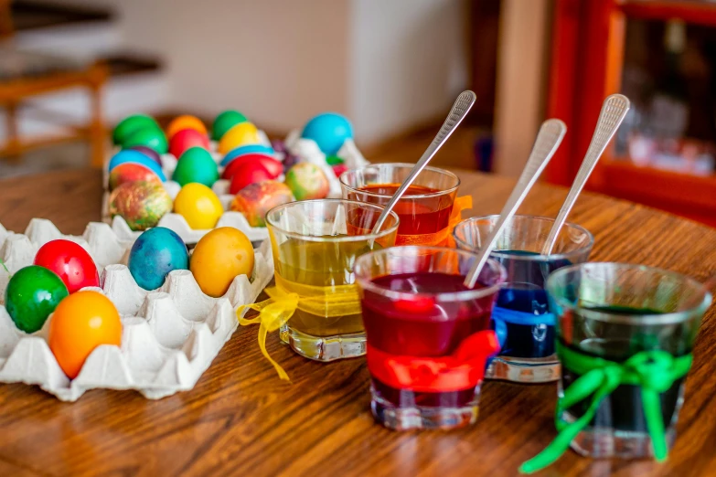 a wooden table topped with different colored eggs, inspired by Károly Patkó, pexels contest winner, process art, beakers of colored liquid, with an easter basket, rainbow coloured rockets, orthodox