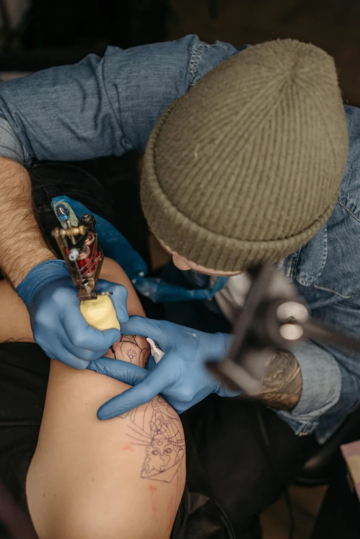a man getting a tattoo on his leg, trending on pexels, hyperrealism, blue, biohacking, ilustration, multi-part