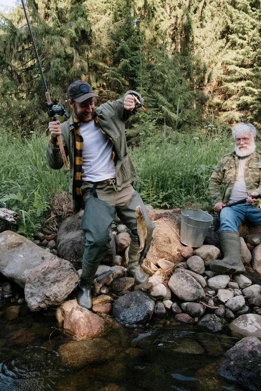 a couple of men sitting on top of a rock next to a river, overalls and a white beard, trout sticking out of pants, dad bod, 2 5 6 x 2 5 6 pixels