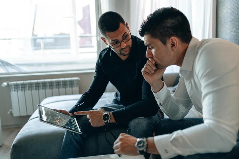 two men sitting on a couch looking at a laptop, pexels contest winner, teaching, professional image, looking serious, instagram post