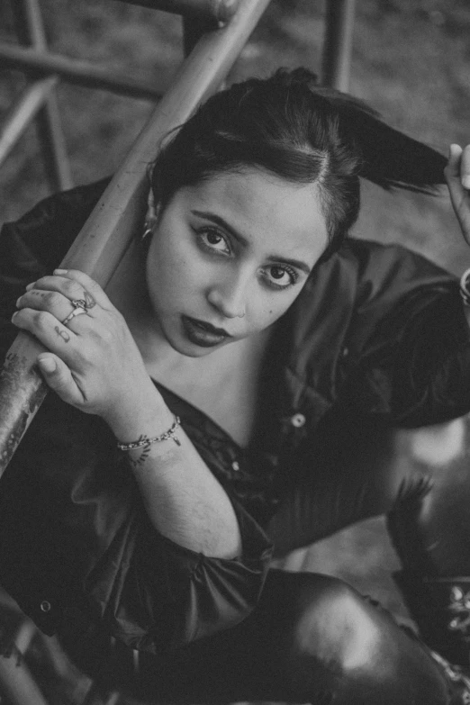 a black and white photo of a woman holding a baseball bat, inspired by irakli nadar, assamese aesthetic, yamy yamy, square, expressive!!!!!