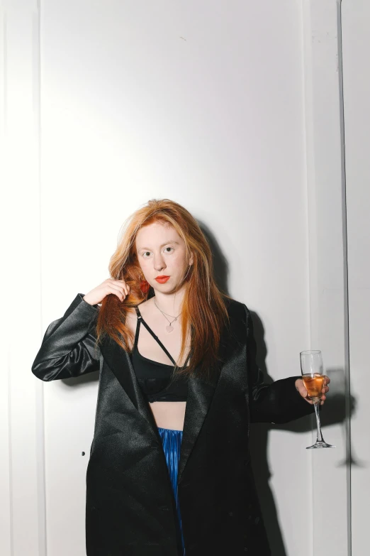 a woman standing in front of a door holding a glass of wine, inspired by Nan Goldin, trending on pexels, renaissance, long glowing red hair, cropped shirt with jacket, ava max, black on white background