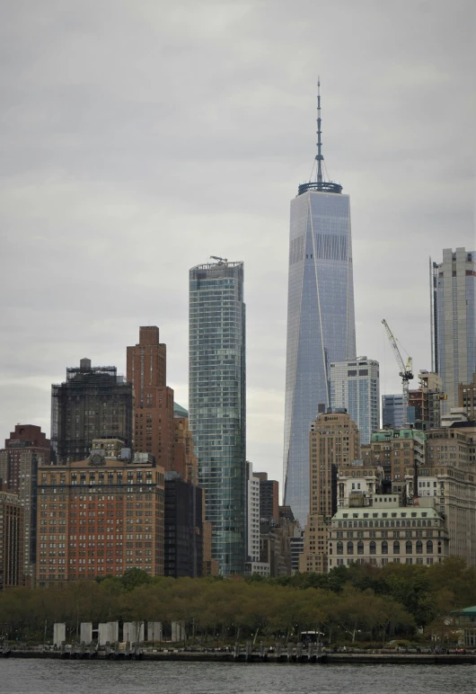 a large body of water with a city in the background, a picture, 9/11, fan favorite, ap photo, gigantic tower