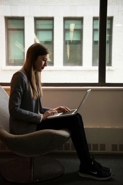 a woman sitting in a chair using a laptop, pexels contest winner, serious business, 15081959 21121991 01012000 4k, good light, instagram post