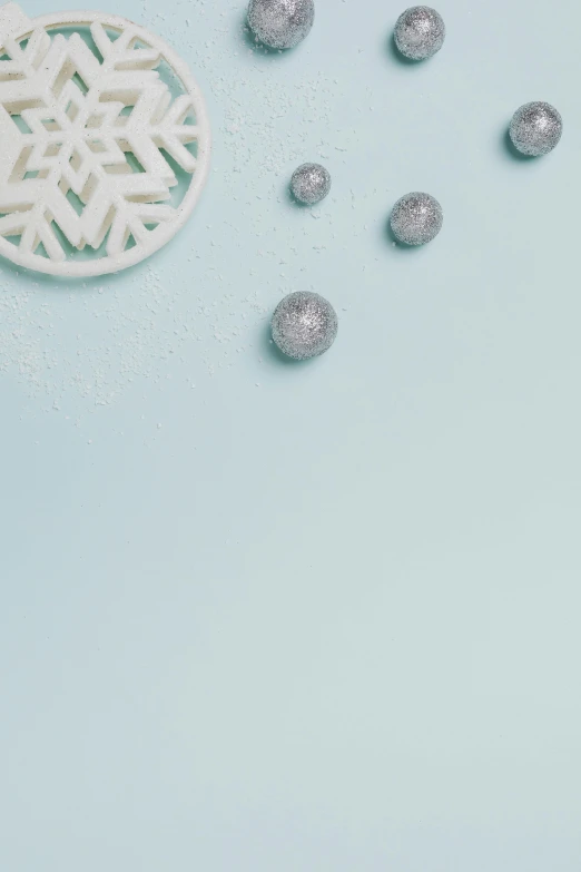 a cup of coffee and a snowflake on a blue background, a black and white photo, inspired by Perle Fine, trending on unsplash, embedded with gemstones, candy decorations, glistening seafoam, background image