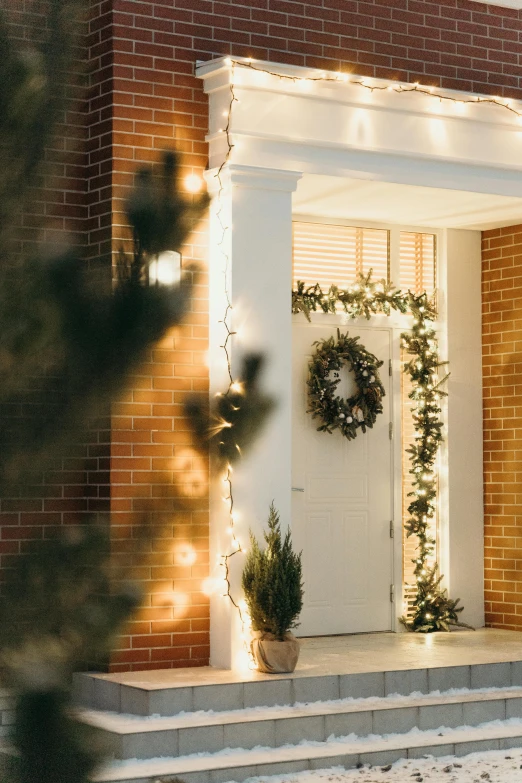 a house with a christmas wreath on the front door, a photo, trending on pexels, soft evening lighting, doorway, bright backlit, profile image