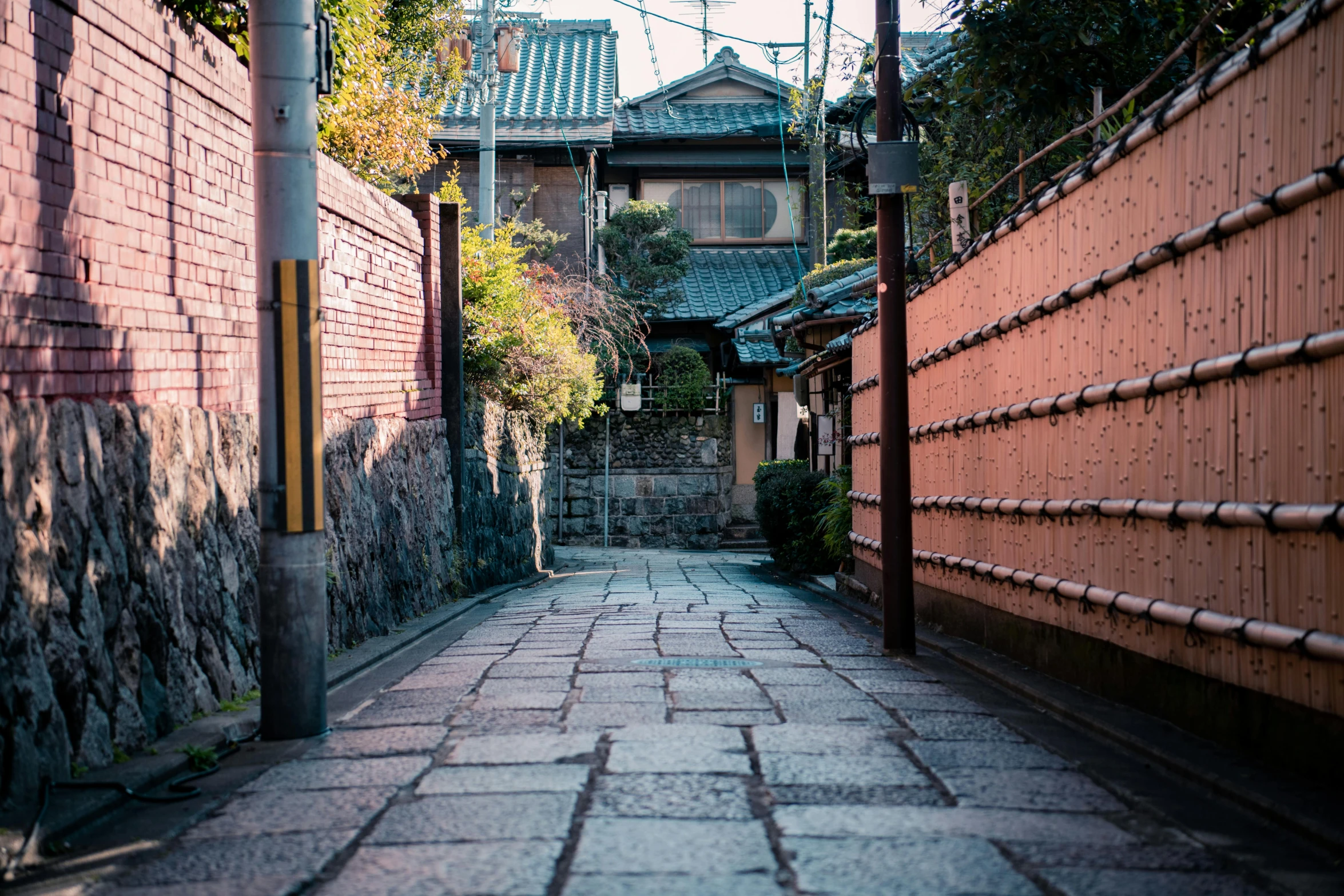 a narrow alley with a building in the background, inspired by Tōshi Yoshida, unsplash, early morning light, colorful tiled architecture, an ancient path, 2 0 0 0's photo