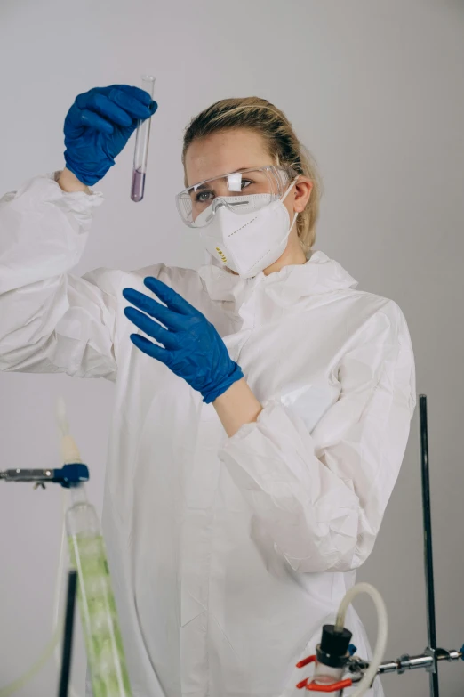 a woman in a lab coat holding a test tube, pexels, process art, wearing gloves, gif, academic clothing, white