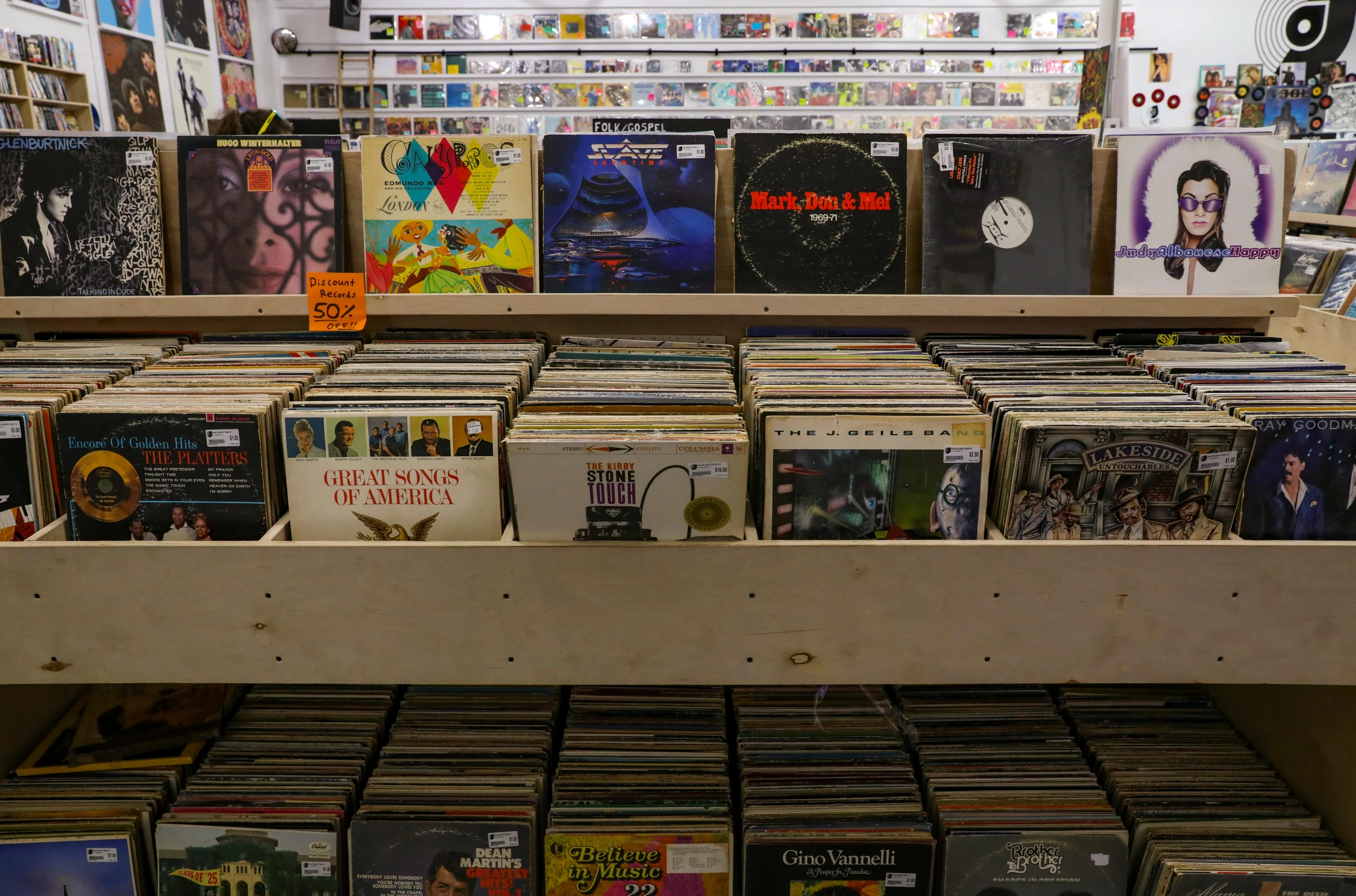 a number of records on a shelf in a store, an album cover, pexels, low fi, sprawling, inside a grand, usa