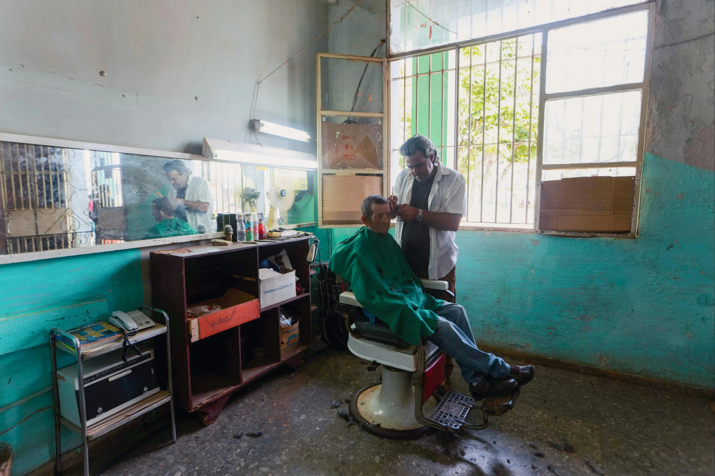 a man getting his hair cut in a barber shop, by William Berra, in chuquicamata, slide show, thumbnail