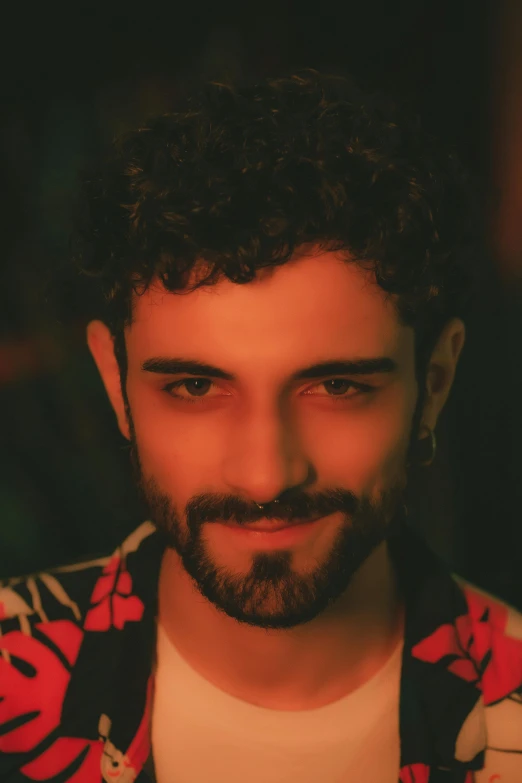a close up of a person with a beard, an album cover, inspired by Alexis Grimou, curly and short top hair, hasan piker, still from a music video, lgbtq