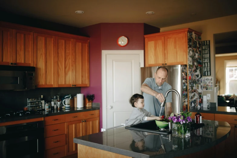 a man and a young boy in a kitchen, by Winona Nelson, pexels, dwell, sink, avatar image, seattle