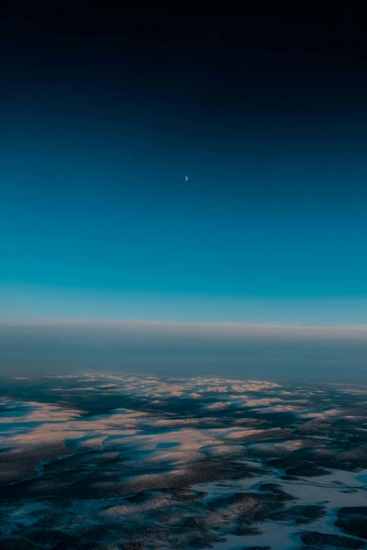 a view of the earth from an airplane, unsplash contest winner, minimalism, soft blue moonlight, twilight ; wide shot, sky gradient, another planet