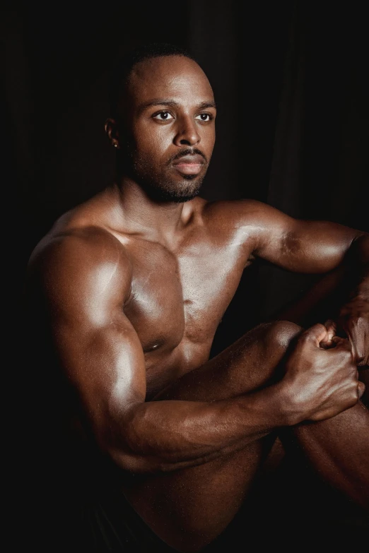 a shirtless man sitting in front of a black background, inspired by Terrell James, showing off his muscles, riyahd cassiem, leathery, white background