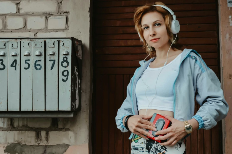 a woman with headphones standing in front of a door, an album cover, by Julia Pishtar, pexels contest winner, russian girlfriend, belly button showing, boombox, 15081959 21121991 01012000 4k