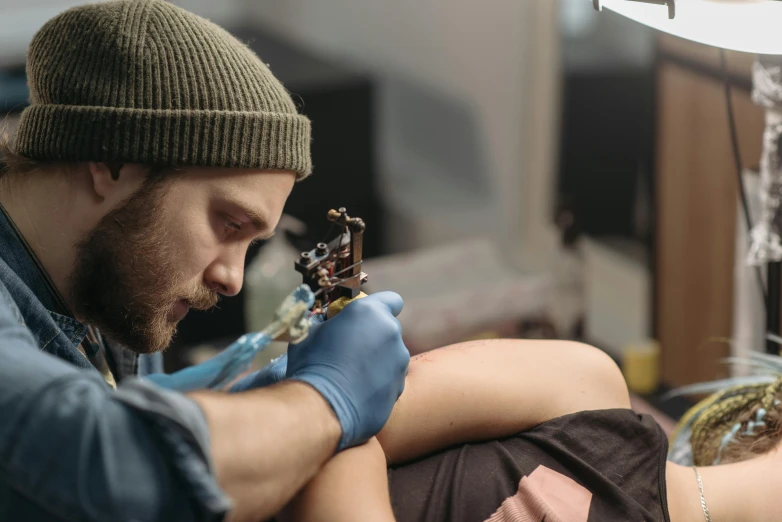 a man getting a tattoo on a woman's arm, a tattoo, by Adam Marczyński, trending on pexels, oill painting, lachlan bailey, as well as the handyboy, stitches