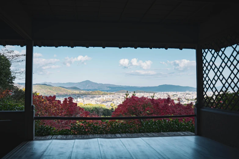 a view of a city from a covered porch, inspired by Sesshū Tōyō, unsplash contest winner, sōsaku hanga, in karuizawa, inside a palace, wide shot photograph, ai weiwei and gregory crewdson