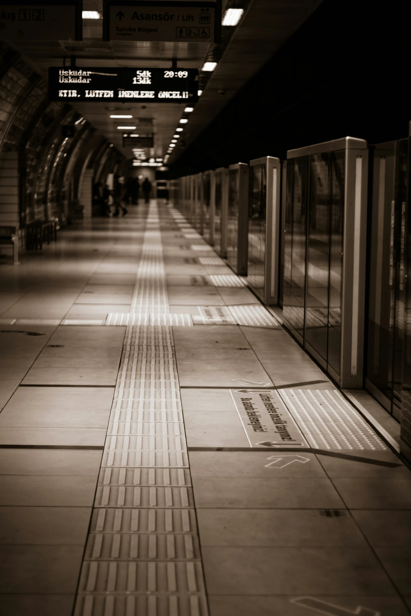 a black and white photo of a subway station, an album cover, unsplash, floor grills, london south bank, sepia, technology