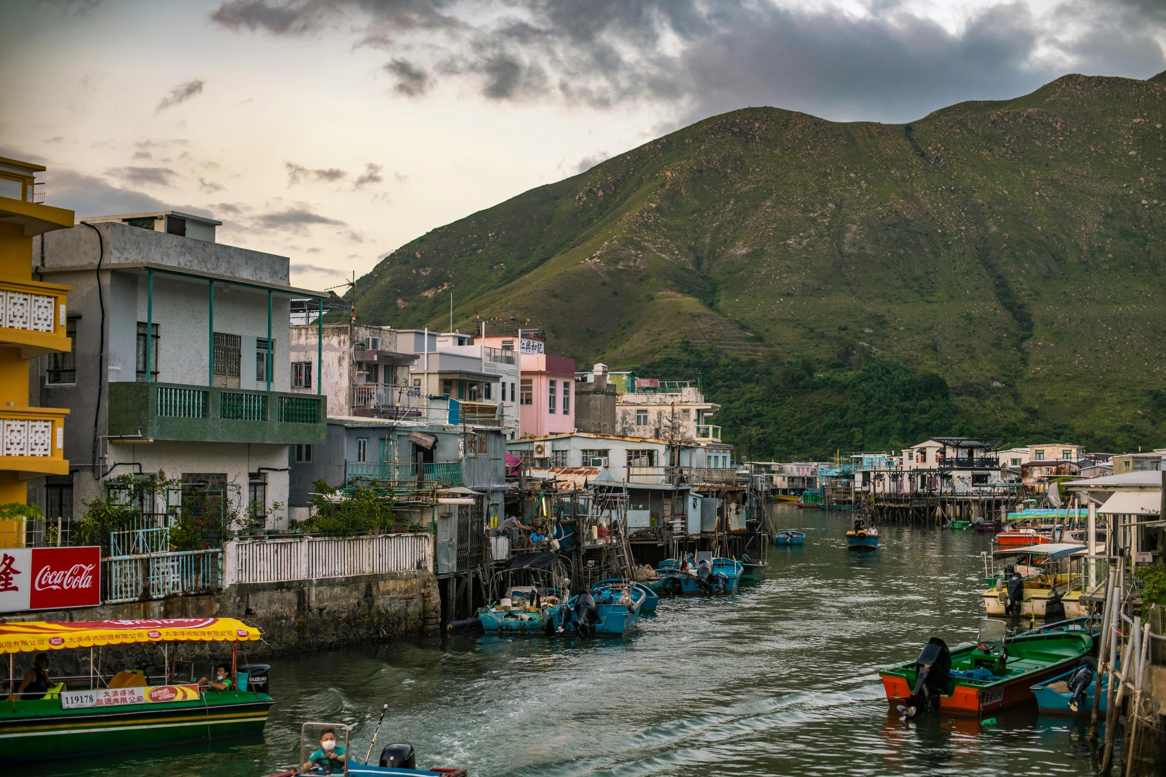 a number of small boats in a body of water, by Joseph Severn, pexels contest winner, kowloon cyberpunk, quaint village, late afternoon, conde nast traveler photo