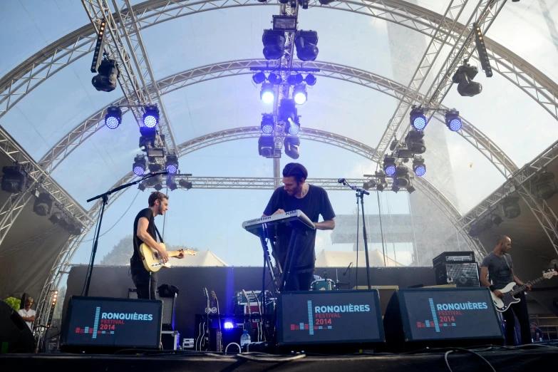 a group of people standing on top of a stage, an album cover, unsplash, synthesizers, in spain, square, marquee