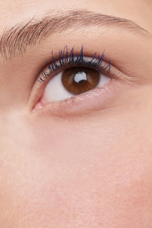 a close up of a woman's eye with blue mascara, inspired by Yves Klein, outline glow, product shot, detailed product image, full body close-up shot