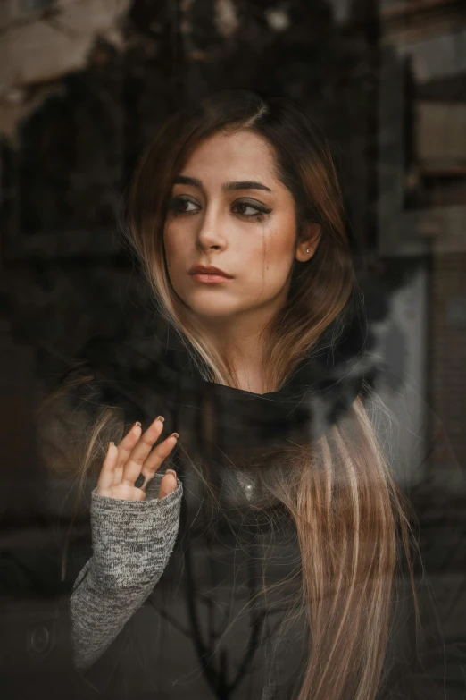 a woman with long hair standing in front of a window, a character portrait, inspired by Elsa Bleda, trending on pexels, young middle eastern woman, sad face, mirroring, an emo girl