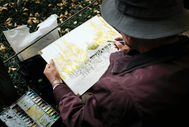 a man in a hat is drawing on a piece of paper, a watercolor painting, inspired by Russell Drysdale, pexels contest winner, al fresco, historic artworks society, painting of